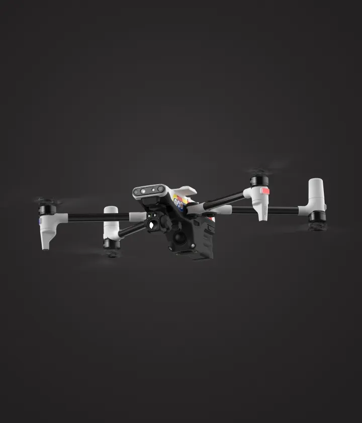 White and black quadcopter drone with visible camera and sensors on a dark background.