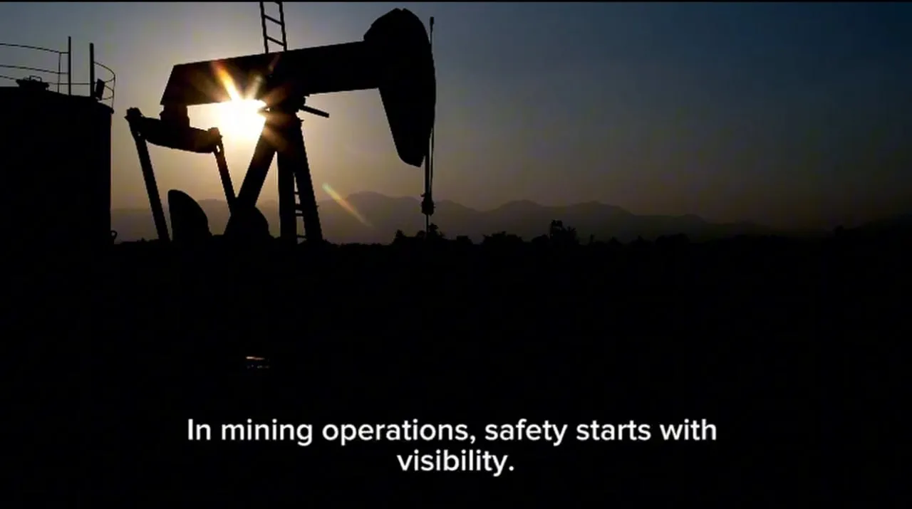 Silhouette of an oil pumpjack against a setting sun with the text 'In mining operations, safety starts with visibility.'