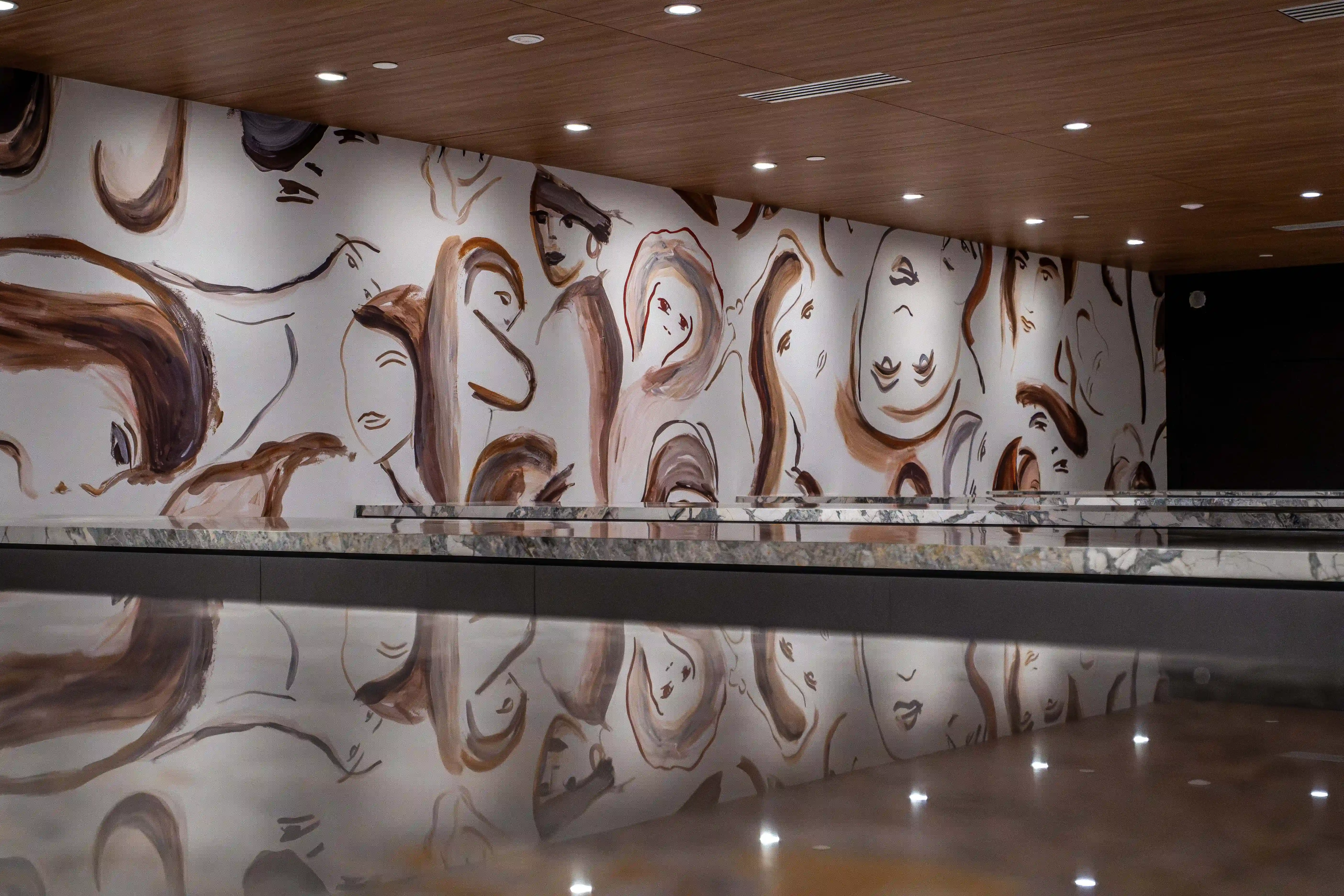 Gallery-like interior with reflective artwork