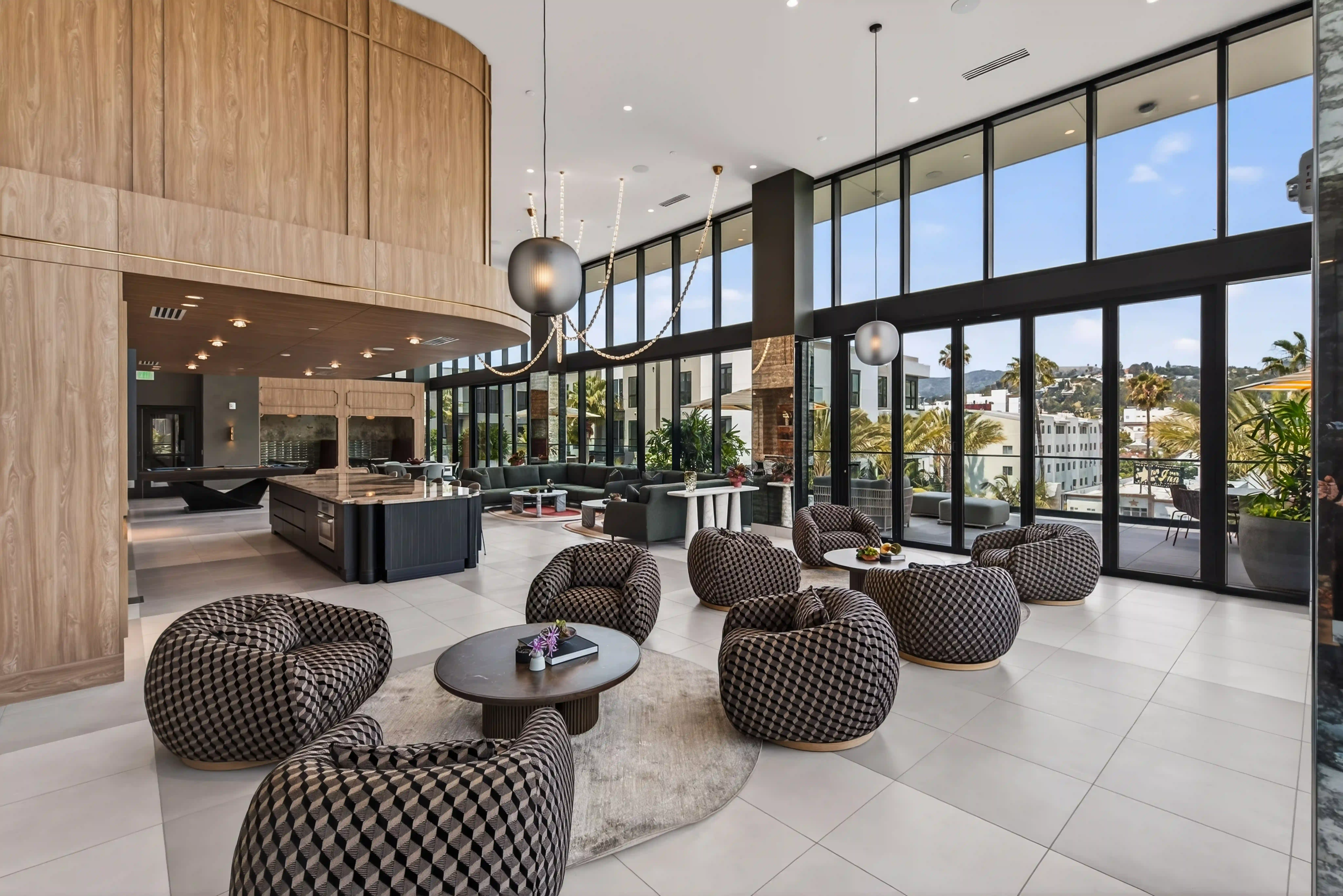 Bright clubhouse lounge with floor-to-ceiling glass