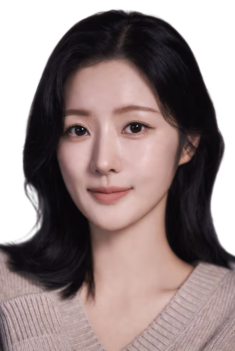 Portrait of a young woman with black hair wearing a beige sweater, smiling softly against a black background.