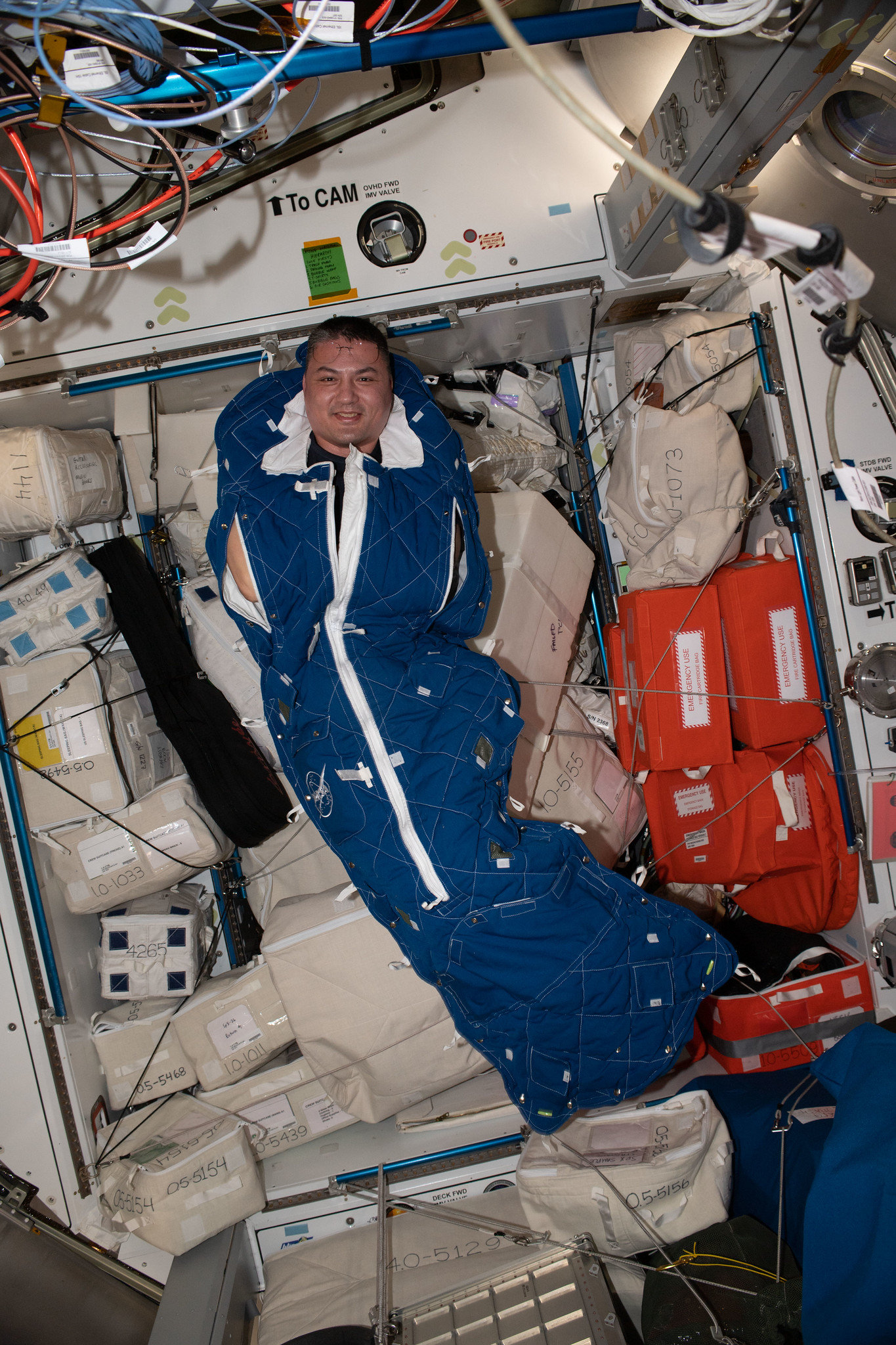 NASA astronaut Kjell Lindgren inside a crew sleeping bag aboard the International Space Station ("Astronaut Kjell Lindgren poses for a portrait inside a crew sleeping bag" by NASA Johnson / CC BY-NC-ND 2.0 via Flickr)