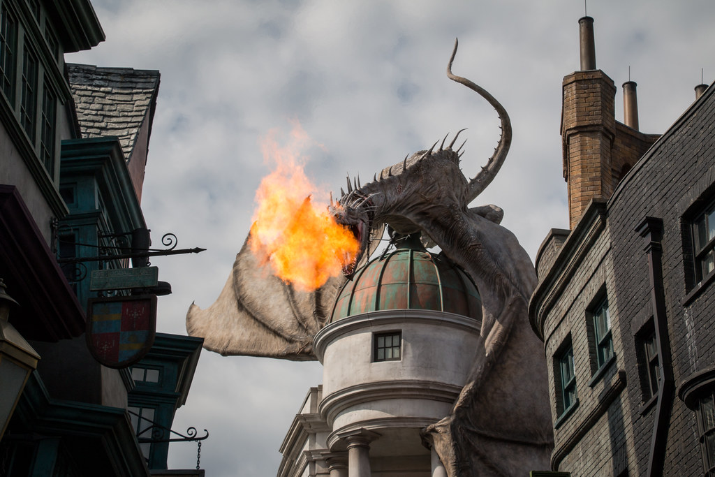 Giant dragon above Gringotts Bank at Universal Orlando breathing fire ("Gringotts Dragon" by HarshLight / CC BY 2.0 via Flickr)