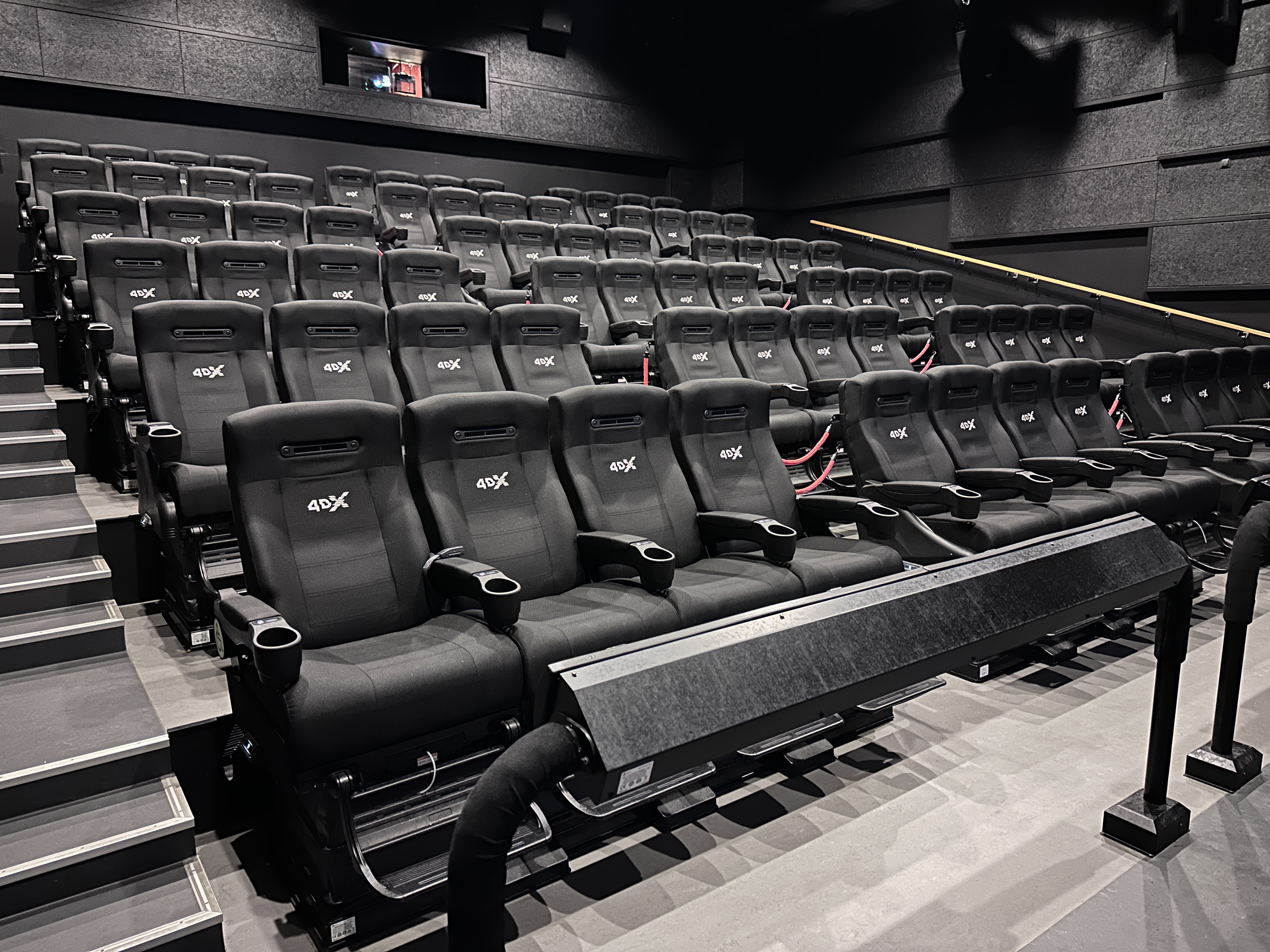 4DX seats in a cinema in Norway. The seats provide motion and environmental effects synced with the on-screen action. ("4DX seats" by Wolfmann / CC BY-SA 4.0 via Wikimedia Commons)
