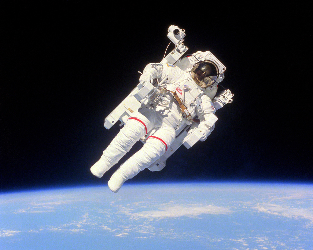 Astronaut Bruce McCandless II goes on a short space walk outside the Space Shuttle Challenger using an MMU