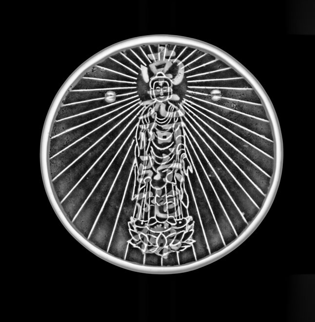 A 19th century Japanese magic mirror, or makyō in Japanese, that reveals a hidden reflection of the Buddha Amida when a light is shone on it