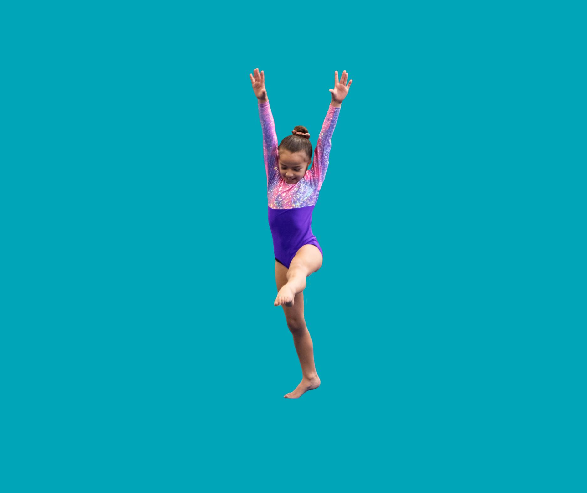 Young girl in purple and pink leotard raising arms and lifting one leg as she performs gymnastics.
