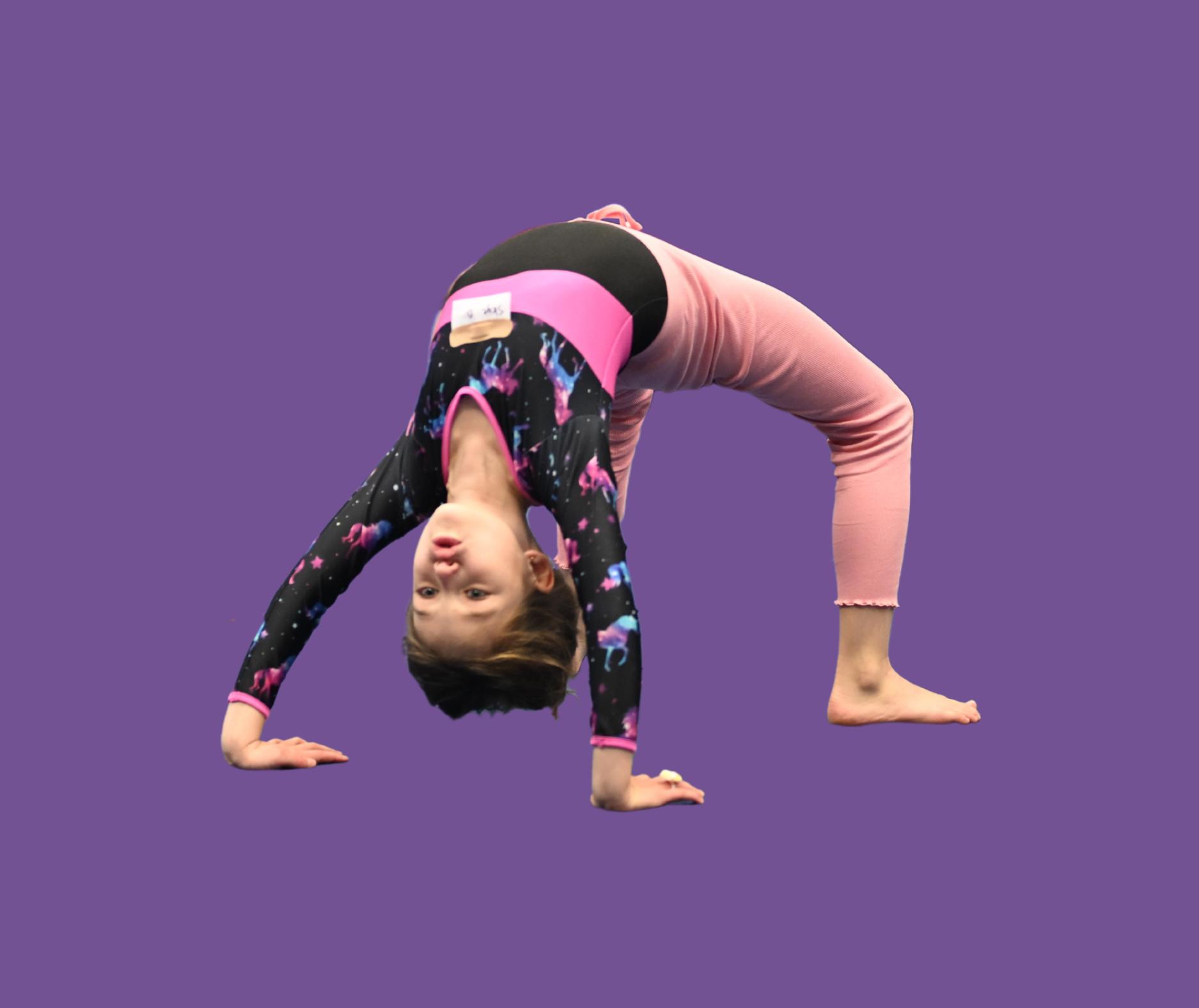 Young girl performing a backbend in a colorful gymnastics outfit on a purple background.