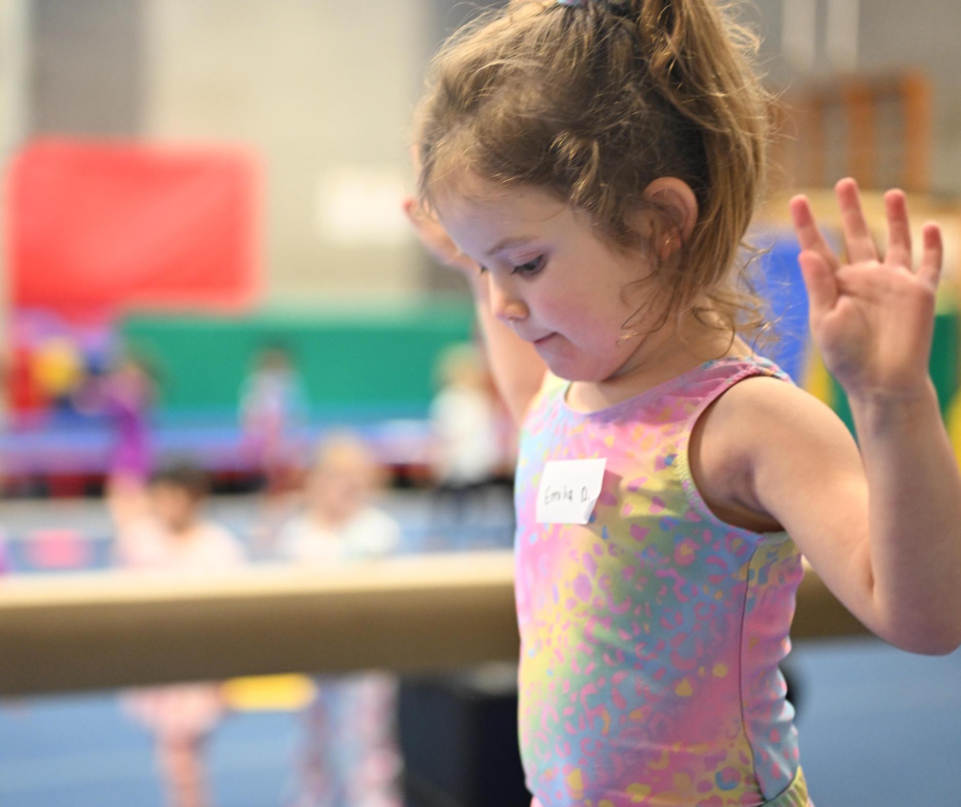 Pre-schooler concentrates as she learns to balance