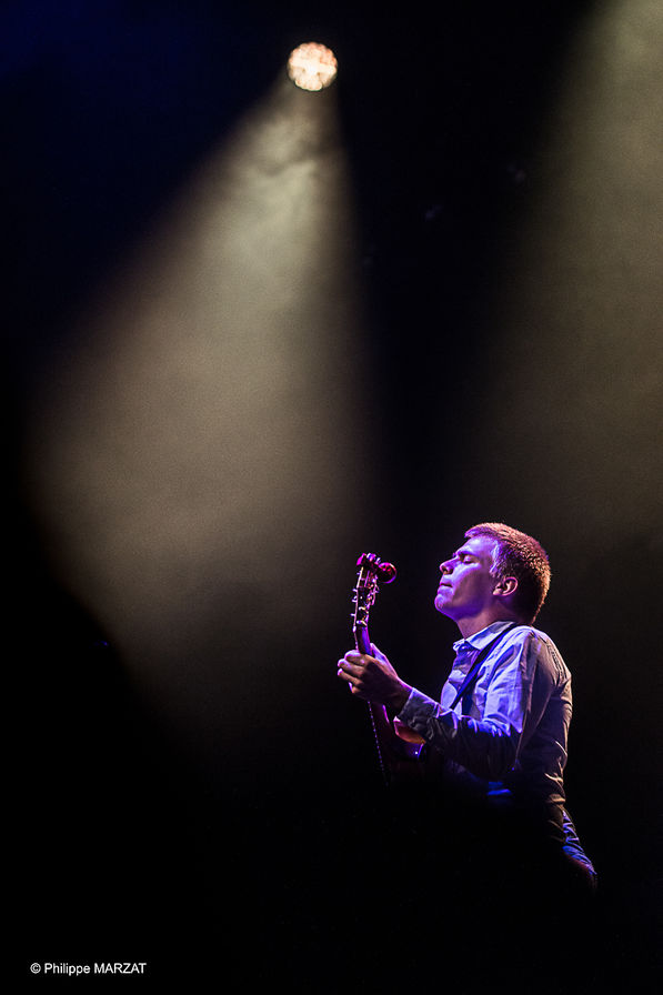 Young Thomas Gaucher playing guitar on stage