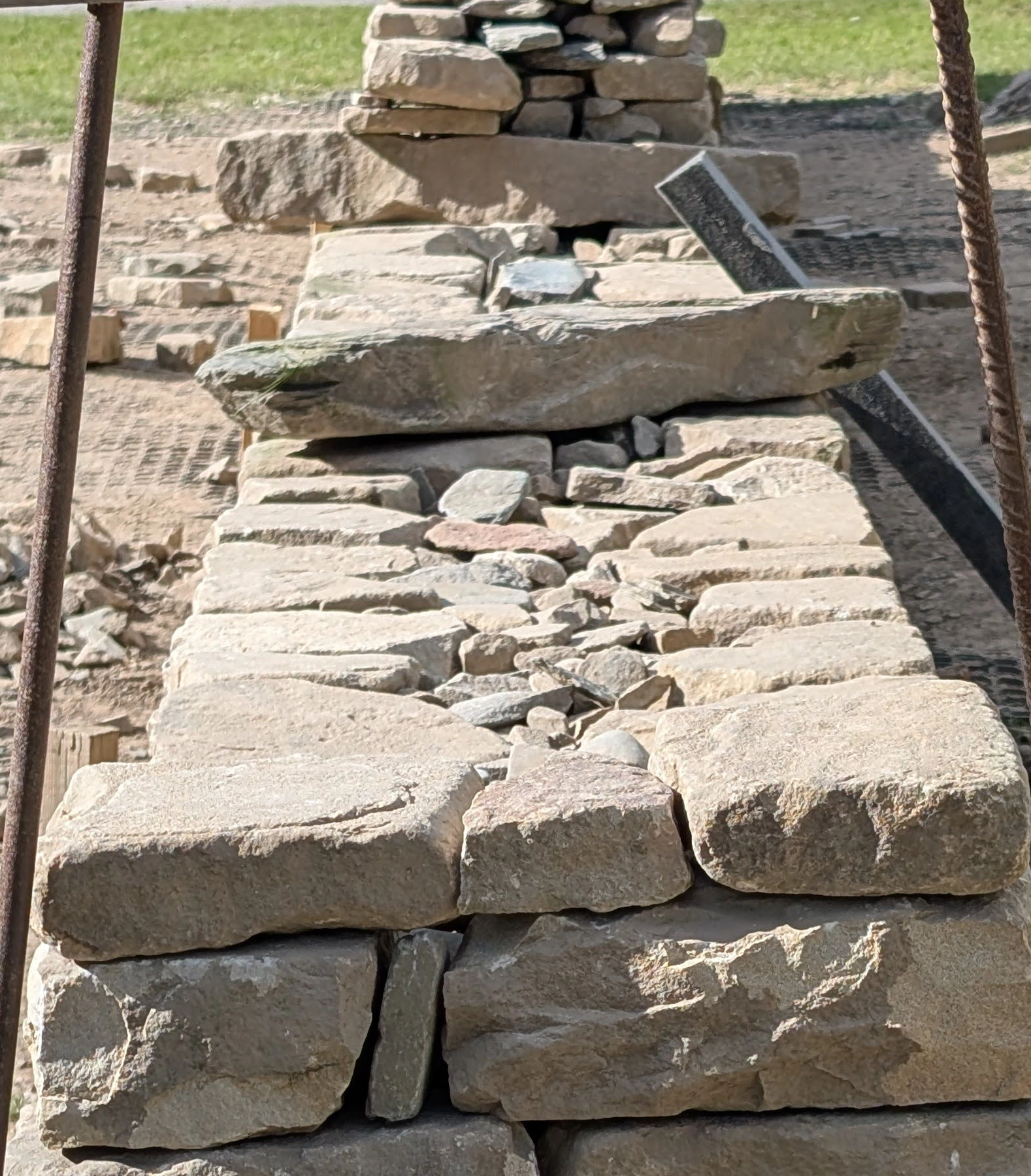 Through stones span the entire width of the wall. They tie both faces together and should be spaced evenly.