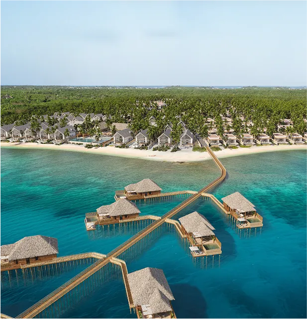 Aerial view of tropical resort with overwater bungalows and beach villas