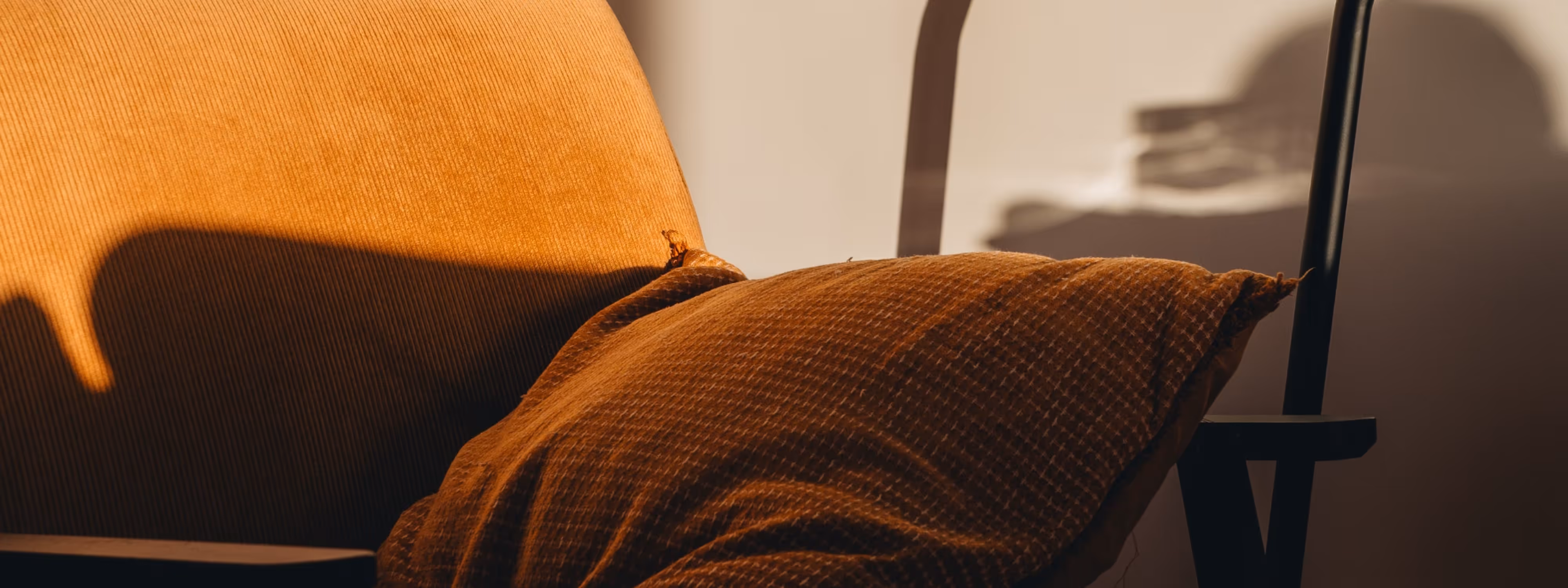 a chair with an orange cushion