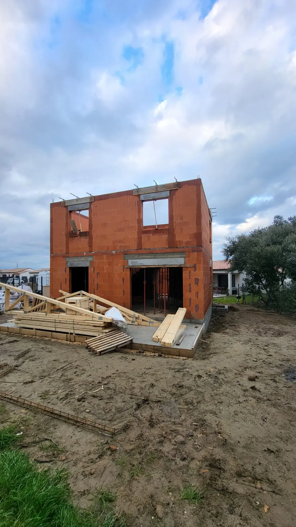 Maison à étage en brique avec fermes de charpente prêtes à poser