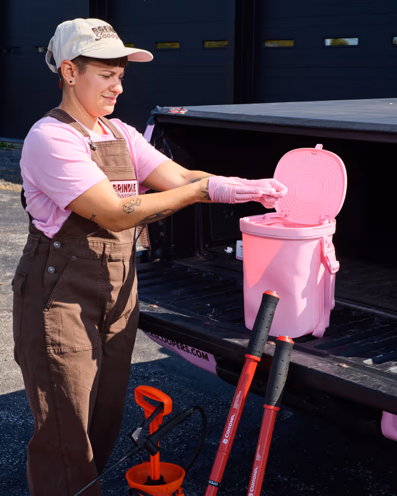 pooper scooper technician bagging pet waste after visiting commercial property