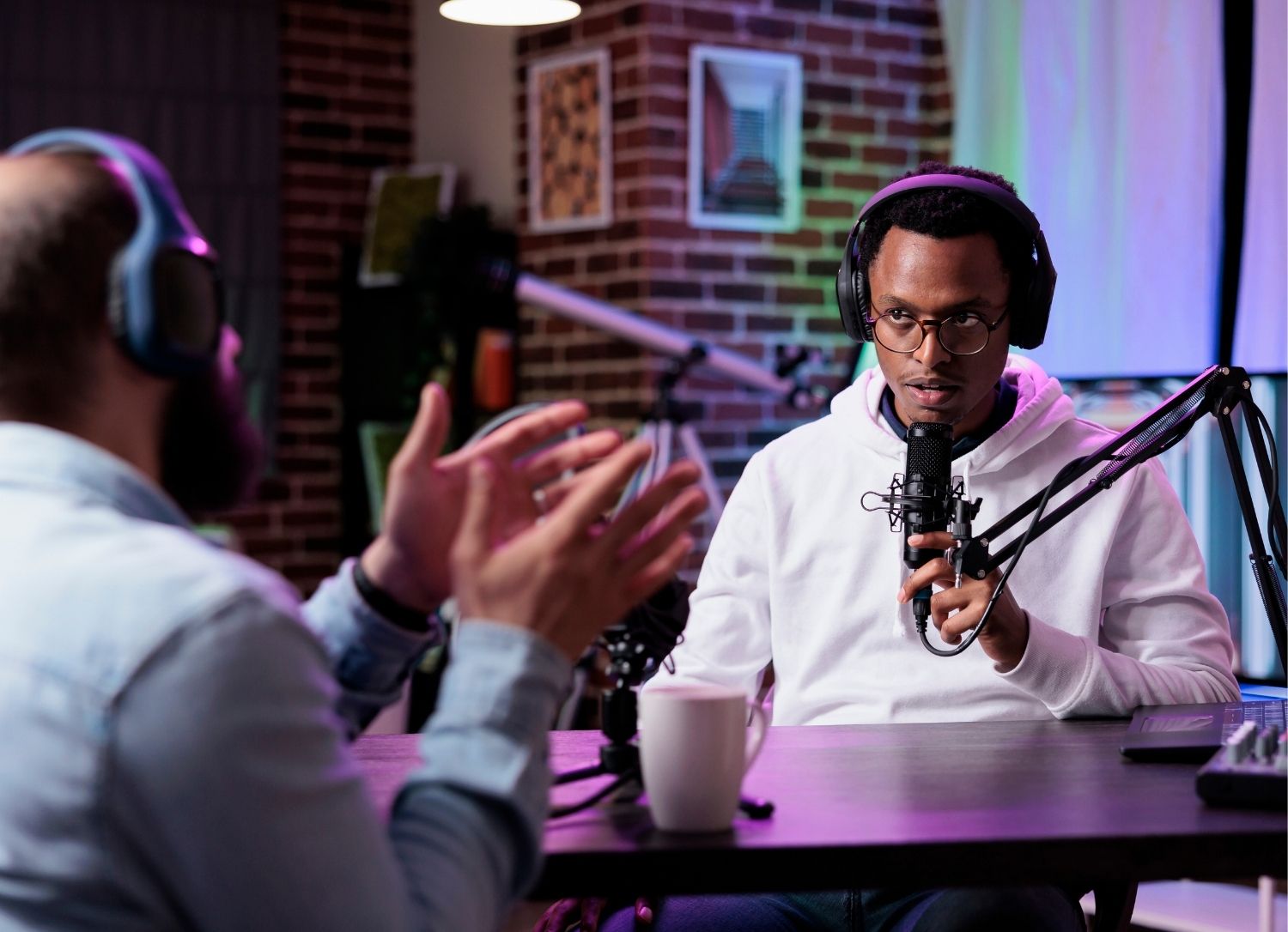 Podcast in process with online coach speaking on microphone, representing online creators and influencers building their businesses.