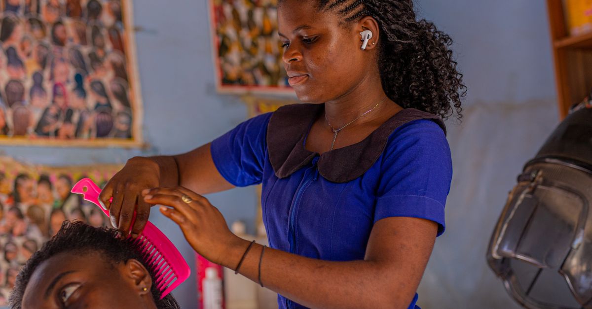 A hairstylist perfecting a client's look in a lively and vibrant salon environment.
