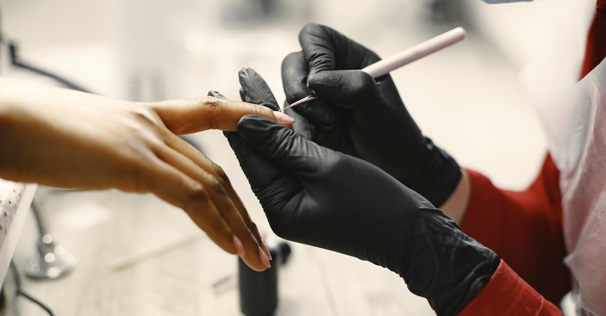 Close-up of a professional manicure session with tools and black gloves in a modern salon.