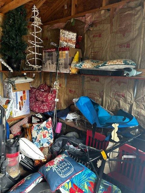 Inside shed filled with trash. 