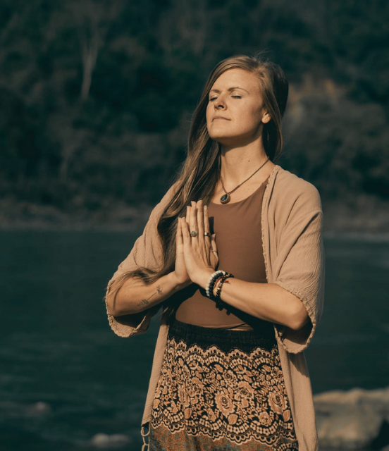 Danie meditating by the river