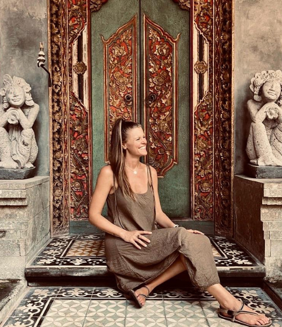 Danie by an ornately carved door