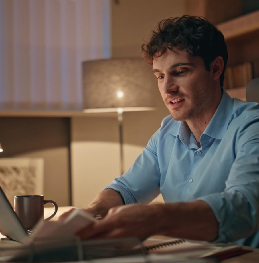 Man working at encase agency working on his laptop