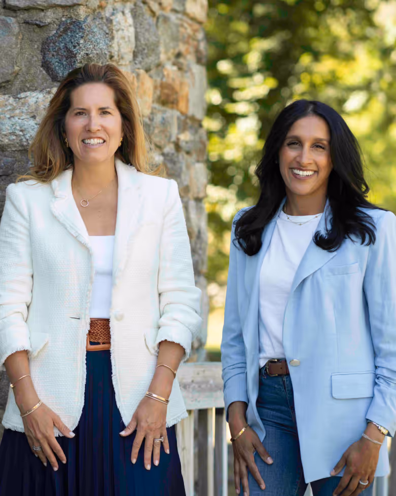 Melissa and Tina standing together smiling.