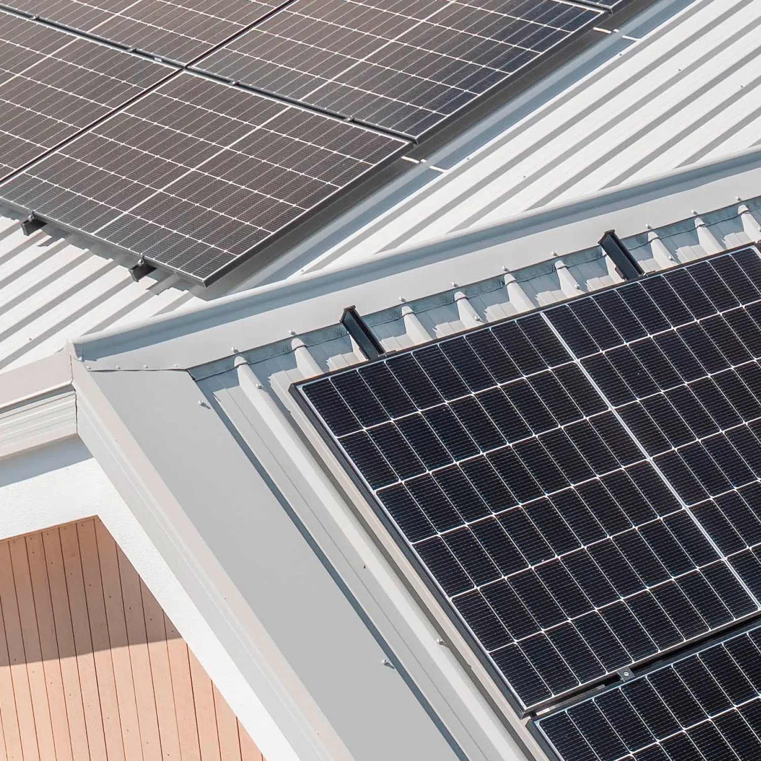 Close-up aerial view of black solar panels installed on a villa roof