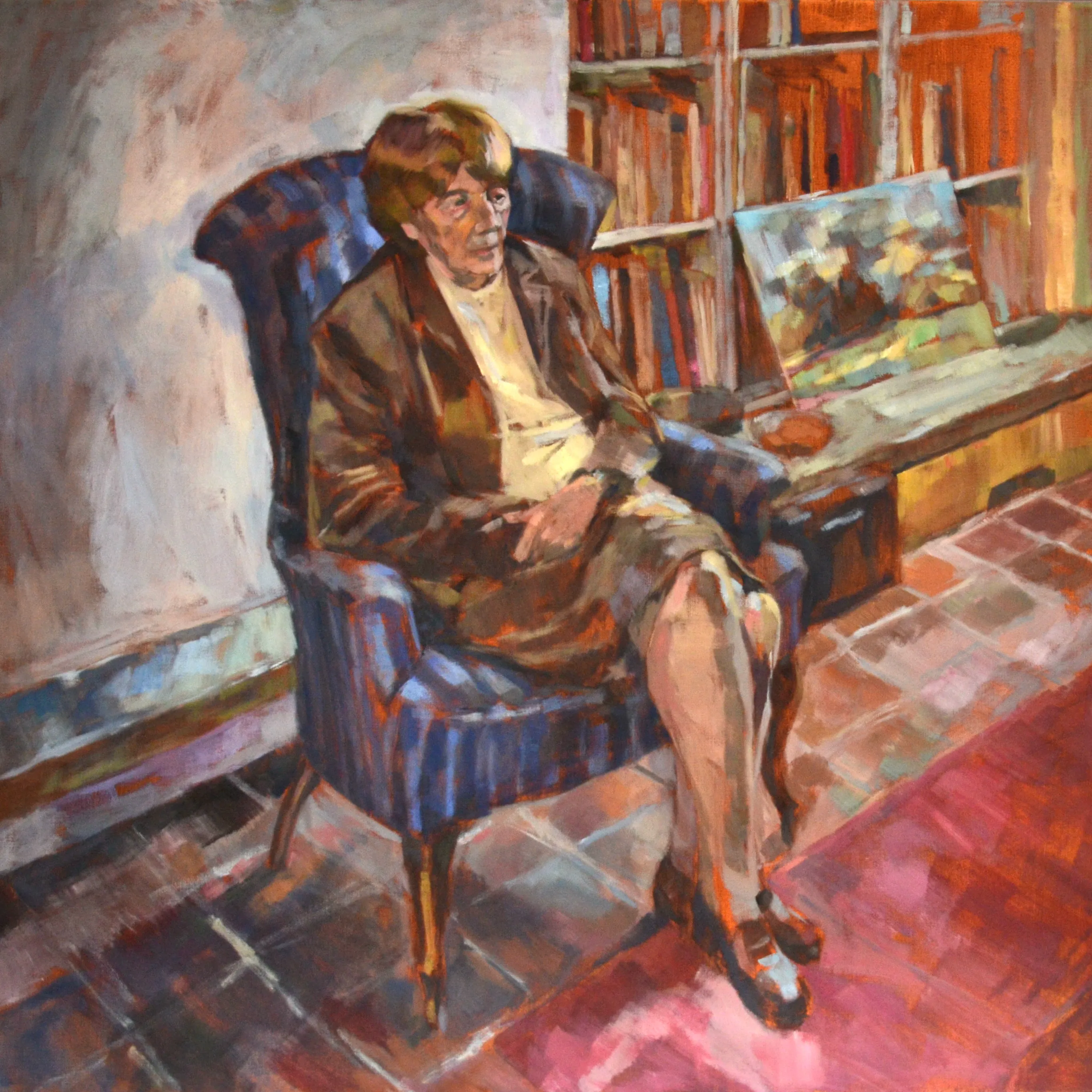 Oil painting of a woman with short hair sitting in a blue armchair in a room with bookshelves and a painting on a table.