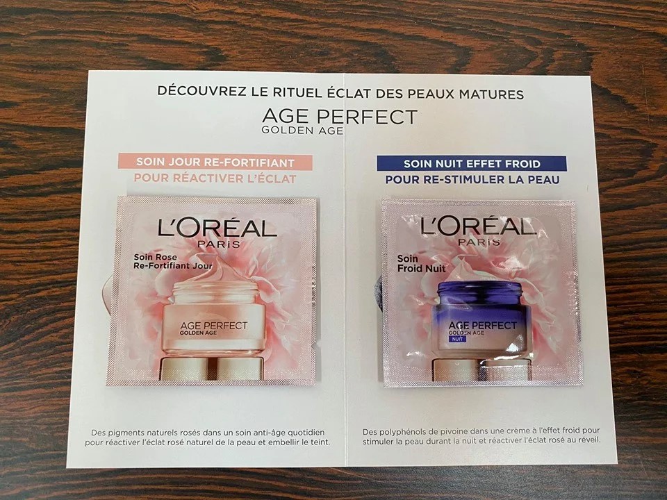 Échantillons de crèmes L'Oréal Paris Age Perfect Golden Age, soin jour re-fortifiant à gauche en pot rose et soin nuit effet froid à droite en pot bleu, sur fond blanc avec texte promotionnel en français.