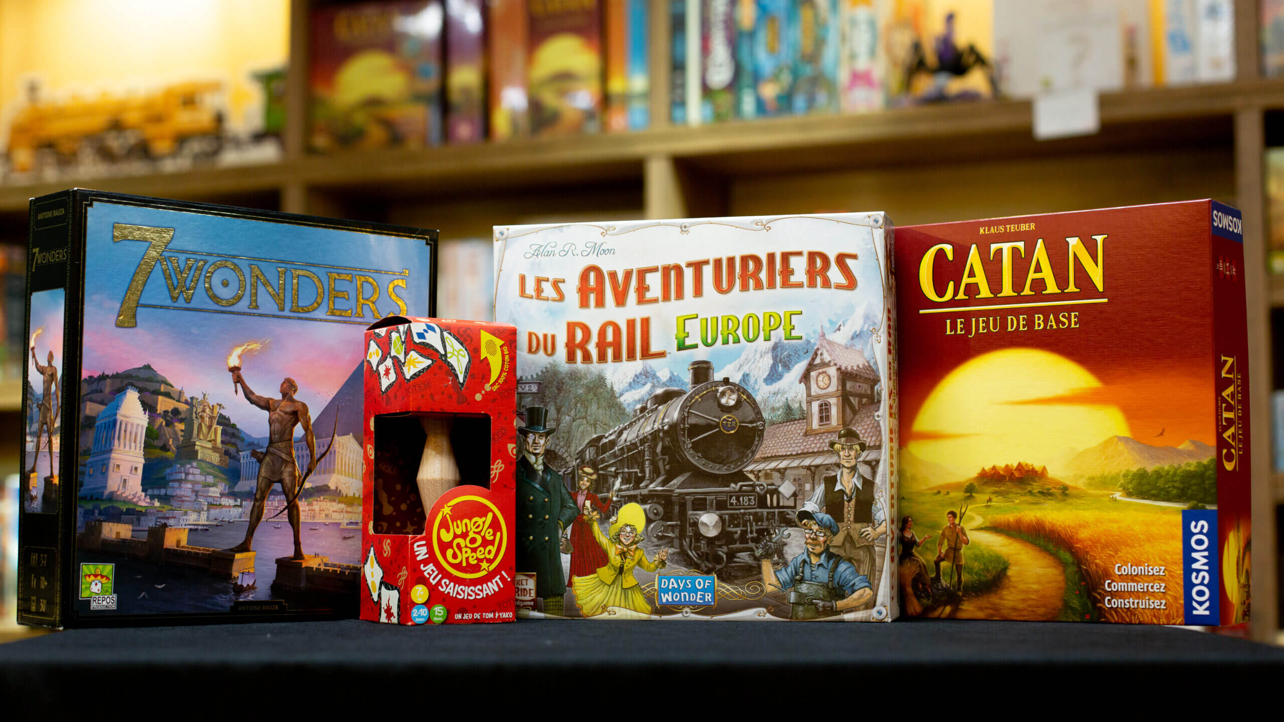 les boites des jeux de société 7 wonders, jungle speed, les aventurier du rail et catan
