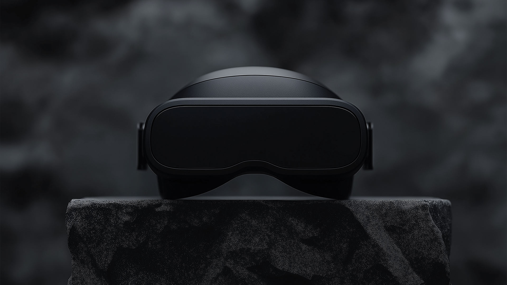 Black futuristic VR glasses on the dark stone.