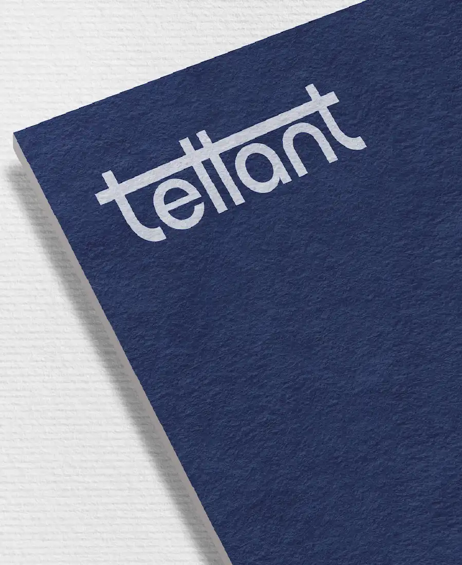 Close-up of textured dark blue paper with white stylized 'tellant' wordmark logo.