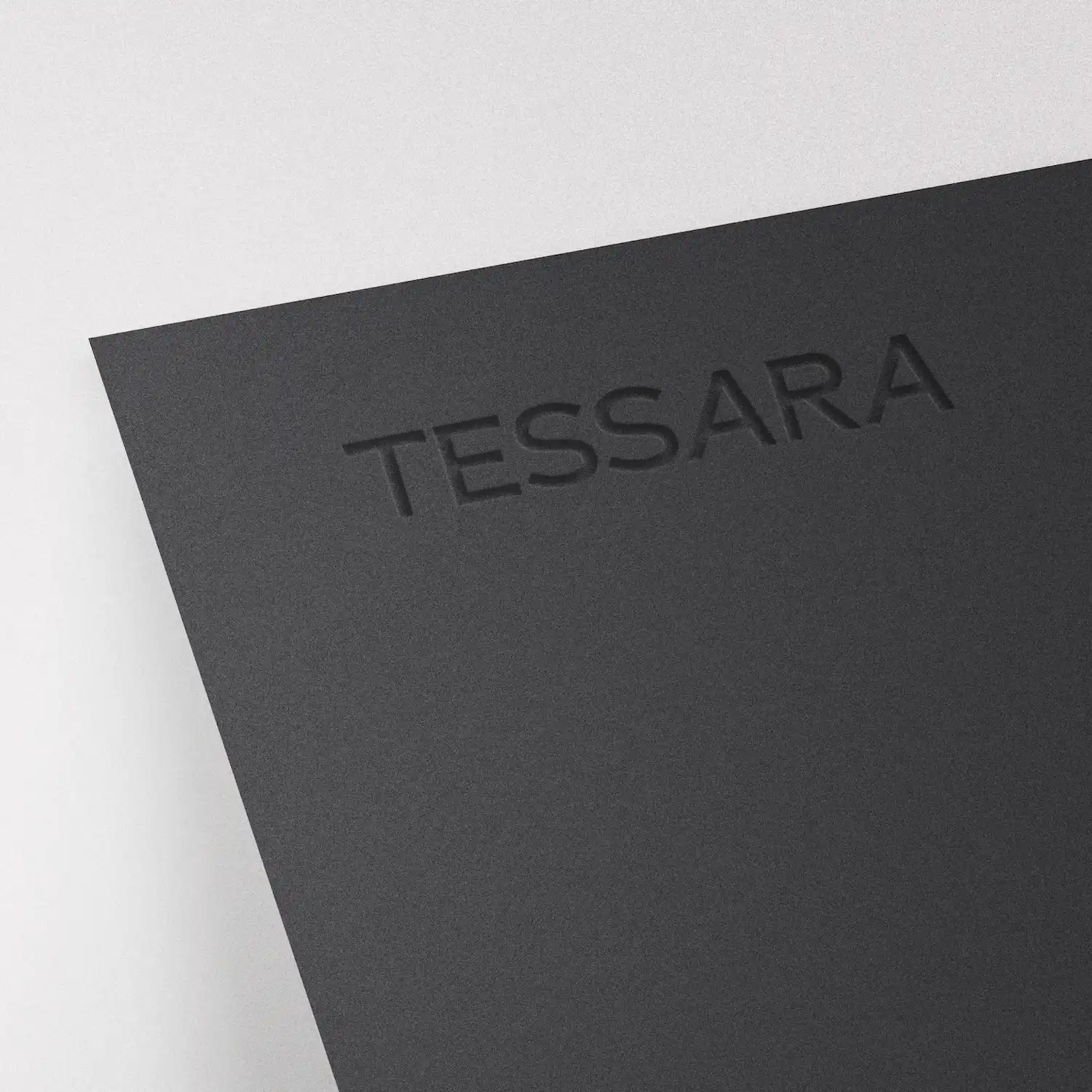 Black textured cover with the word TESSARA embossed on the top right corner.
