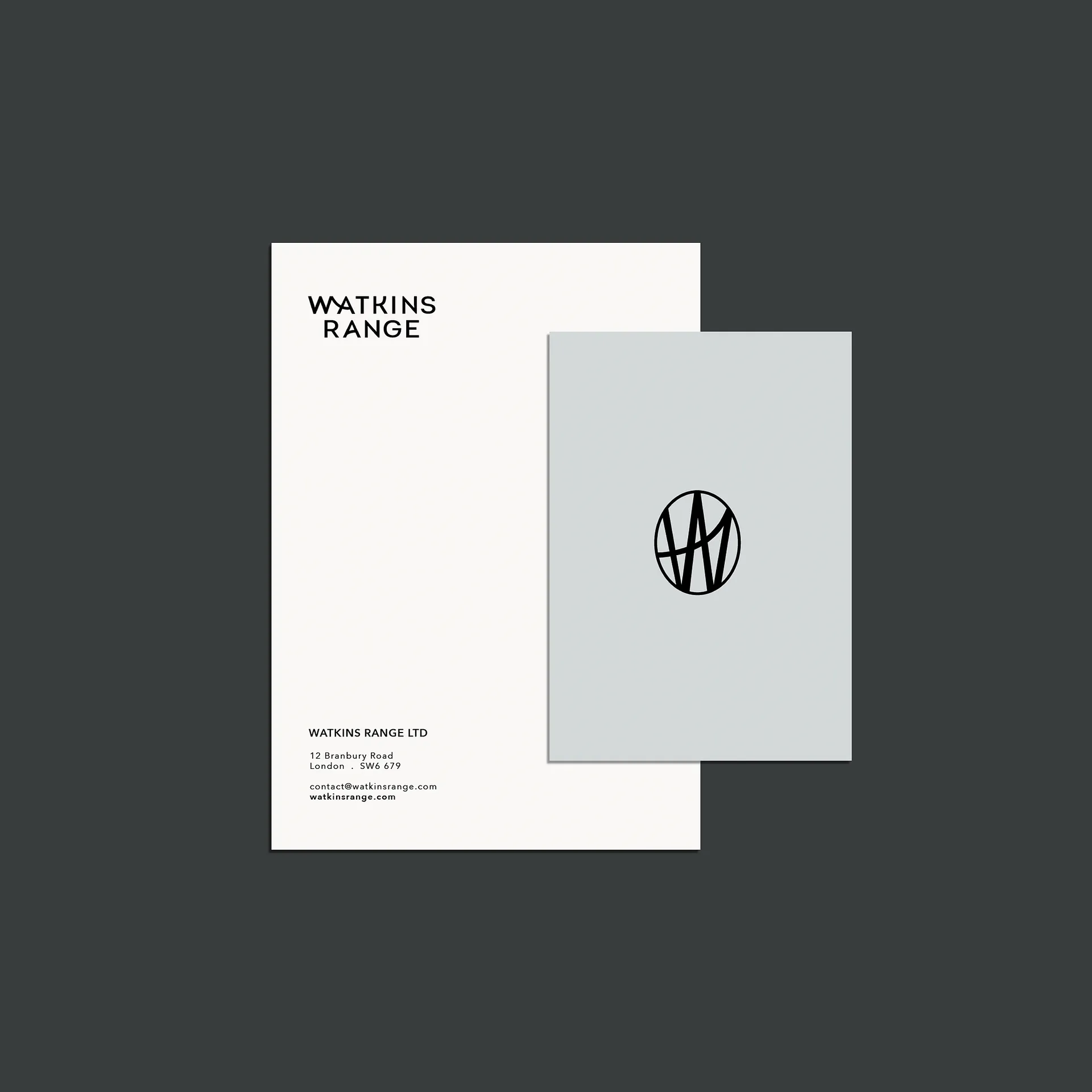 Two stationery sheets on dark background: one white with 'Watkins Range' text and contact details, one grey with a black circular logo containing stylised letters.