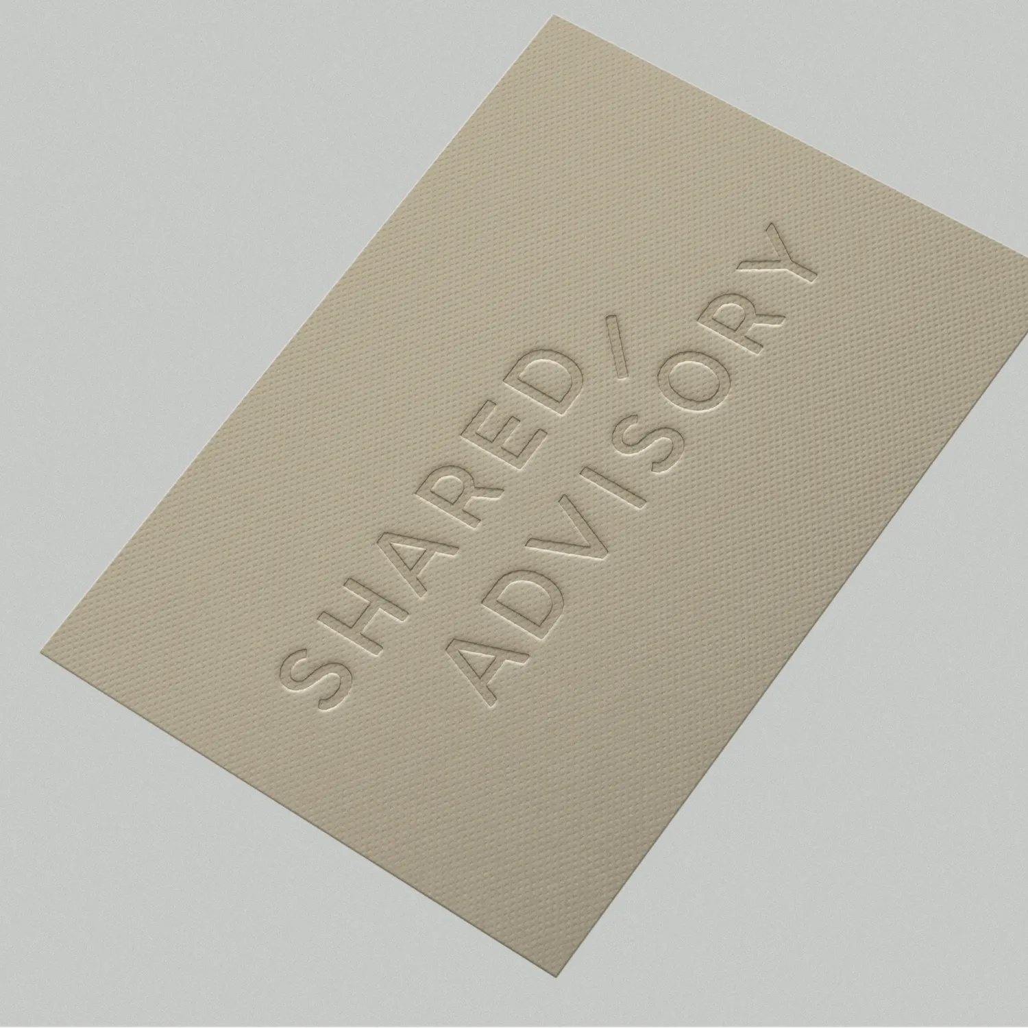 Tan textured card embossed with the words SHARED ADVISORY in capital letters.