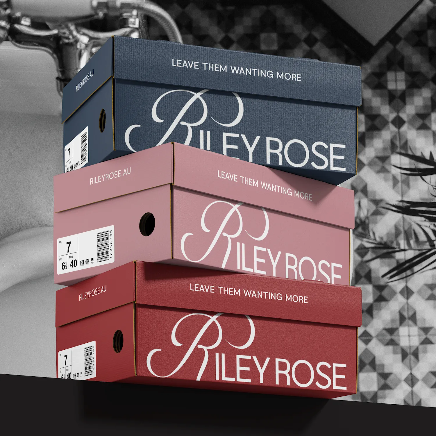 Stack of three Riley Rose shoe boxes in blue, pink, and red with the slogan 'Leave Them Wanting More' on the lids.
