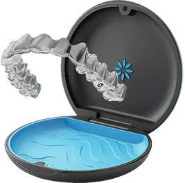 Clear dental aligner displayed above an open black and blue storage case.