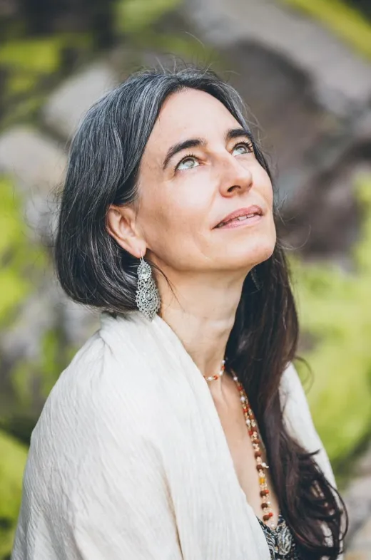 Woman gazing upward with serene expression.