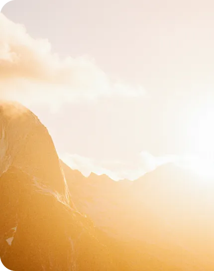 Sunlit mountain peak at dawn.