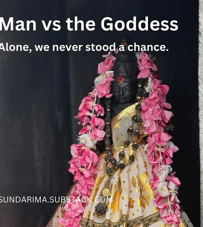 Statue of a goddess adorned with flowers and traditional attire