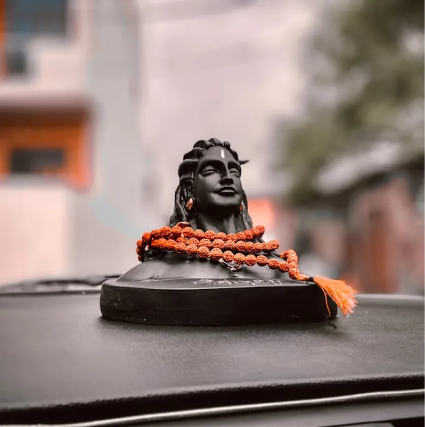 Small Shiva statue with orange cord
