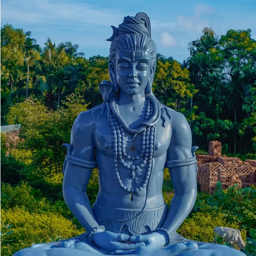 Blue Shiva statue meditating in nature
