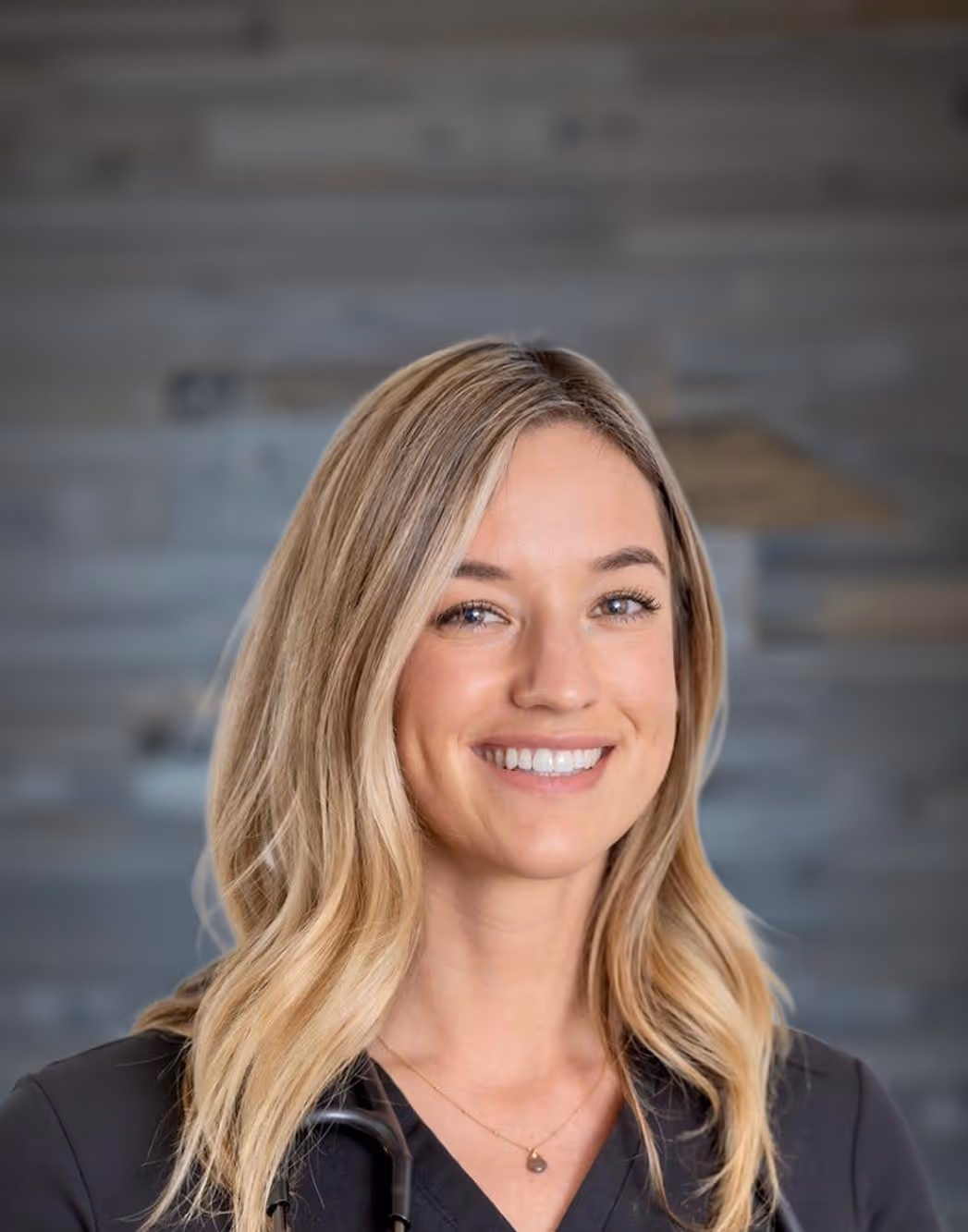 A Professional headshot of Jordan Carney, CRNP, Certified Registered Nurse Practitioner at Paragon Sports Medicine, smiling in clinical attire.