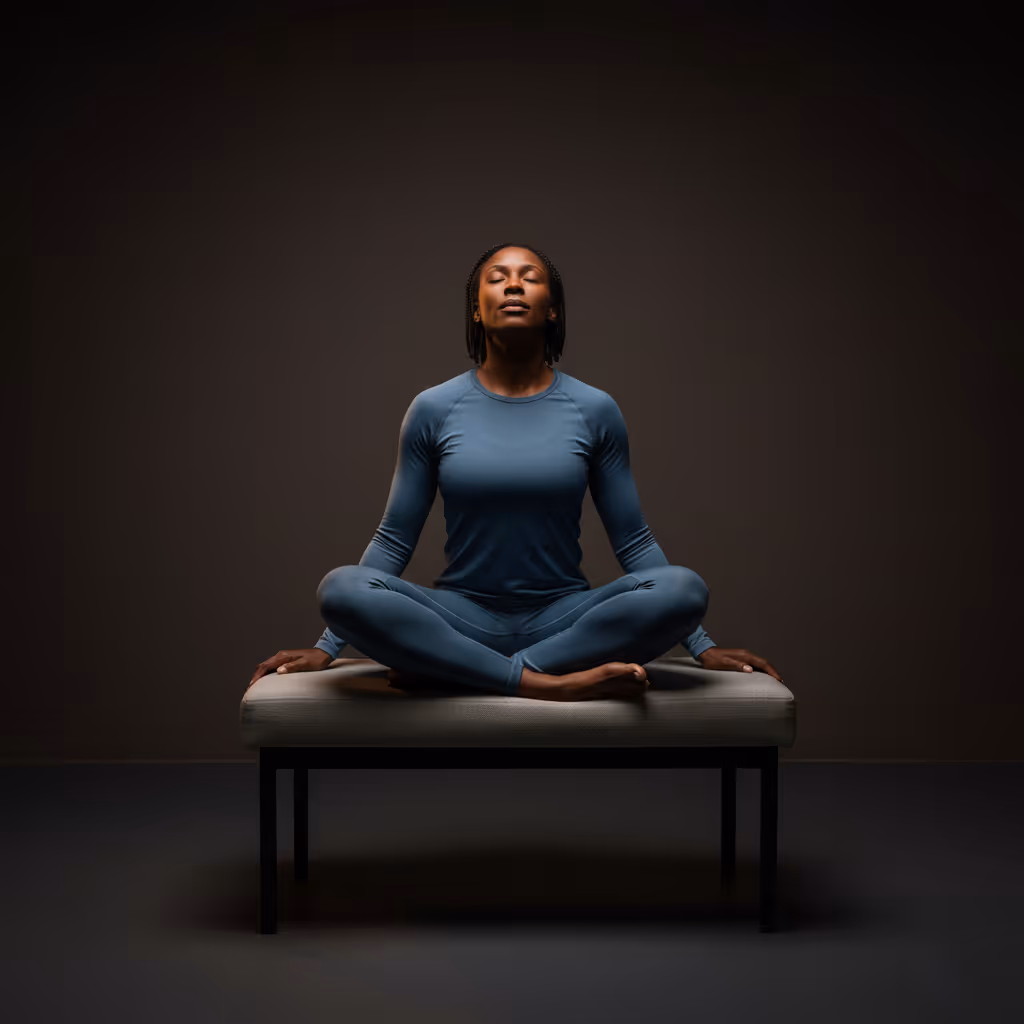 Man seated indoors with a soccer ball in natural light, representing Paragon’s musculoskeletal recovery expertise and regenerative treatment focus.