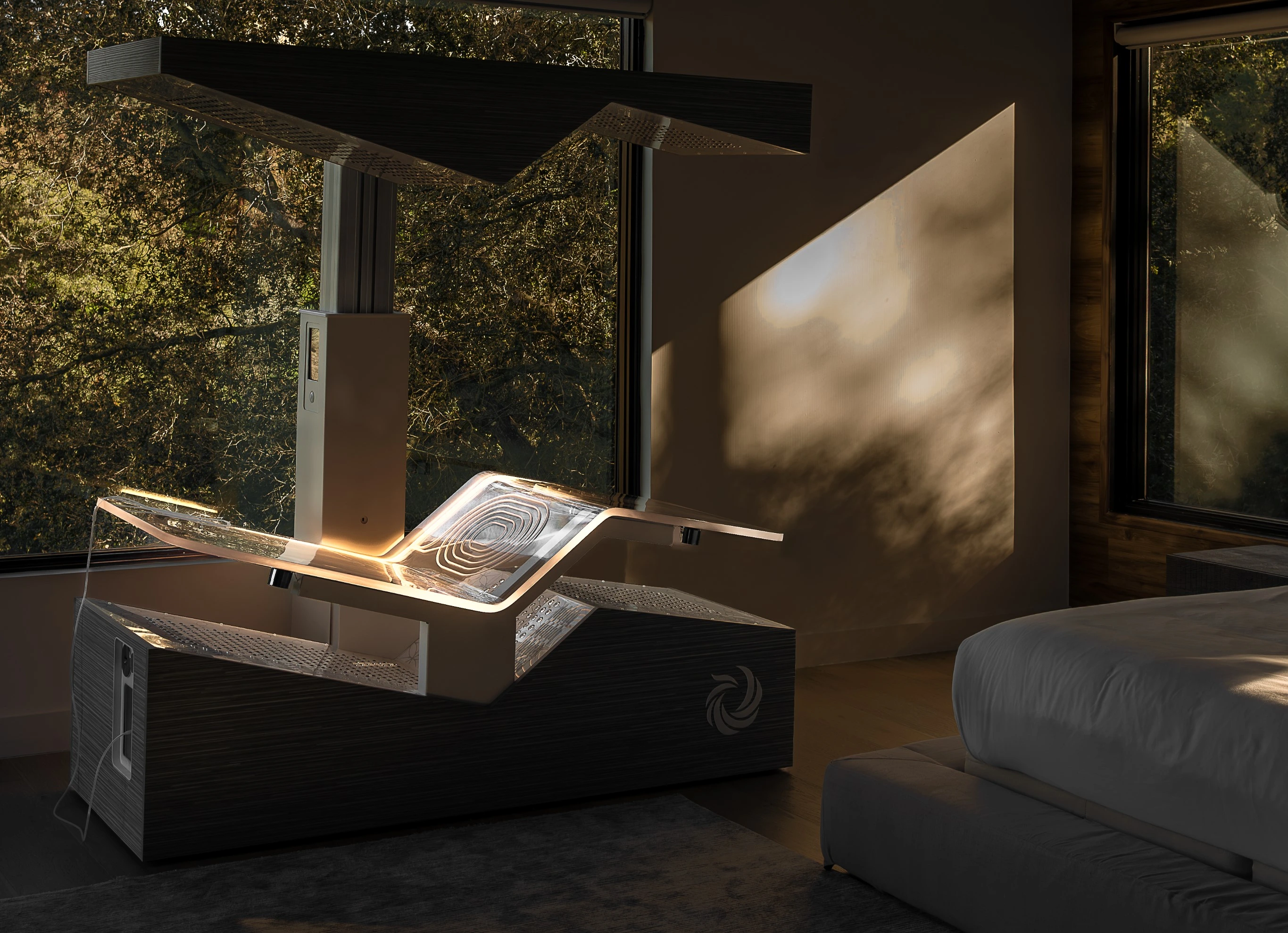 The Ammortal Chamber with its light panel glowing, in a room with large windows and forest views