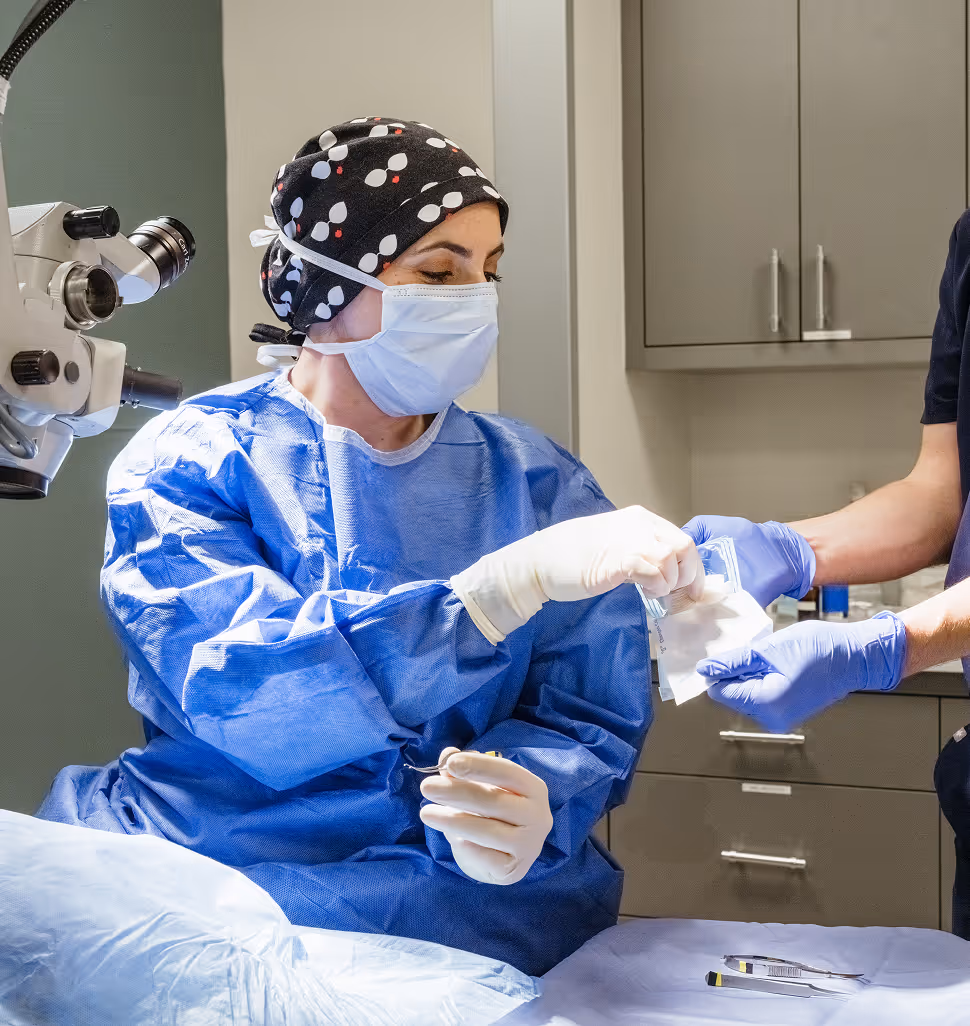 veterinary ophthalmologist preparing for surgery in operating room