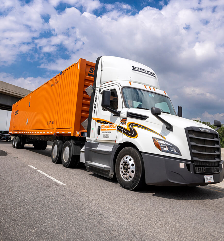 Semi-truck transporting orange intermodal container for efficient freight delivery