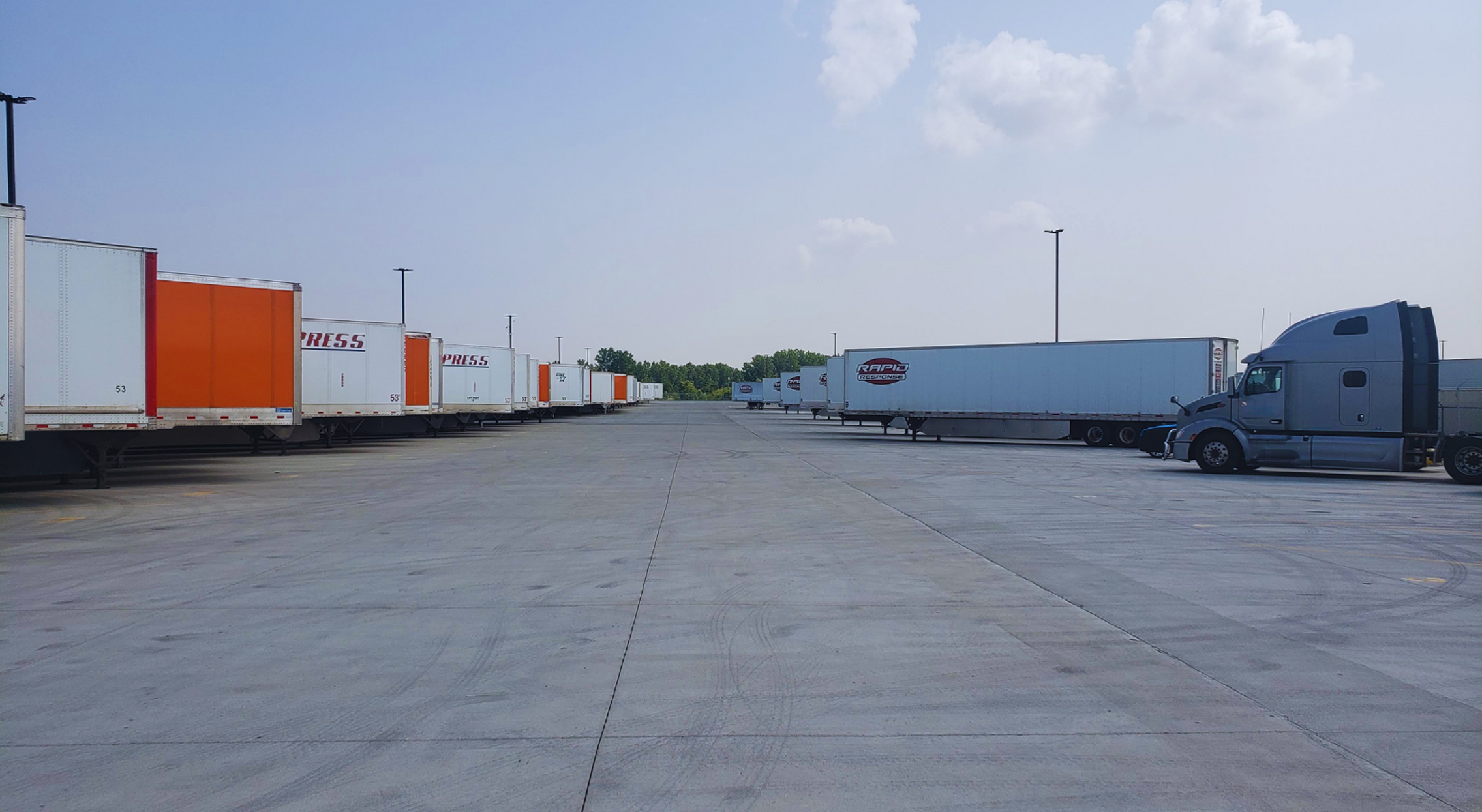 Semi-trailers parked in logistics yard representing drop and hook freight services