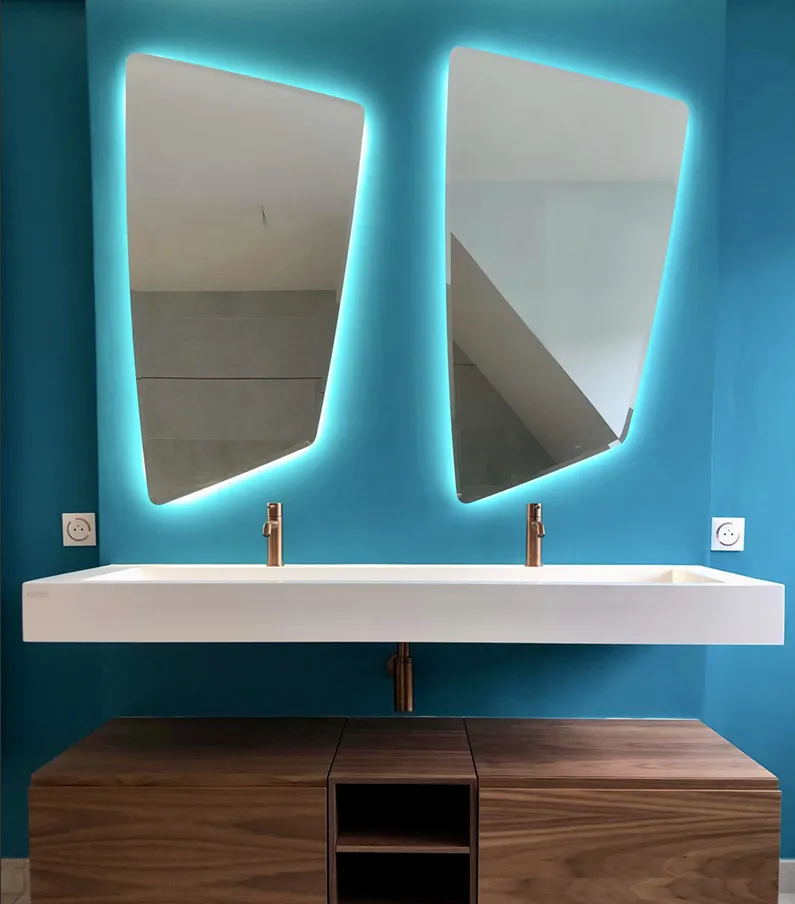 Salle de bain bleu canard avec double vasque et miroirs rétroéclairés
